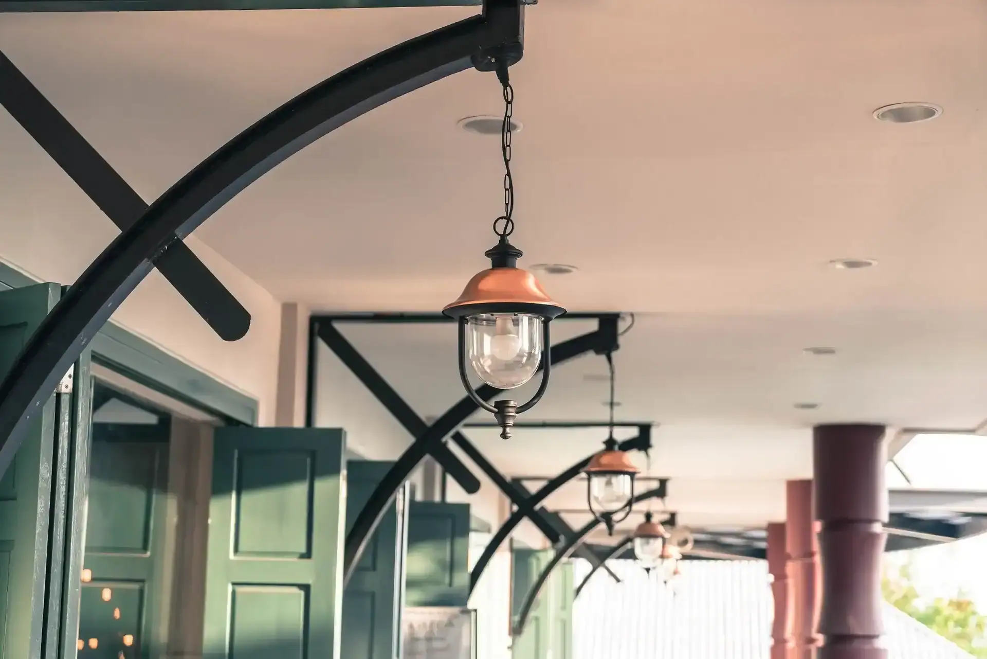 A covered porch with hanging lanterns