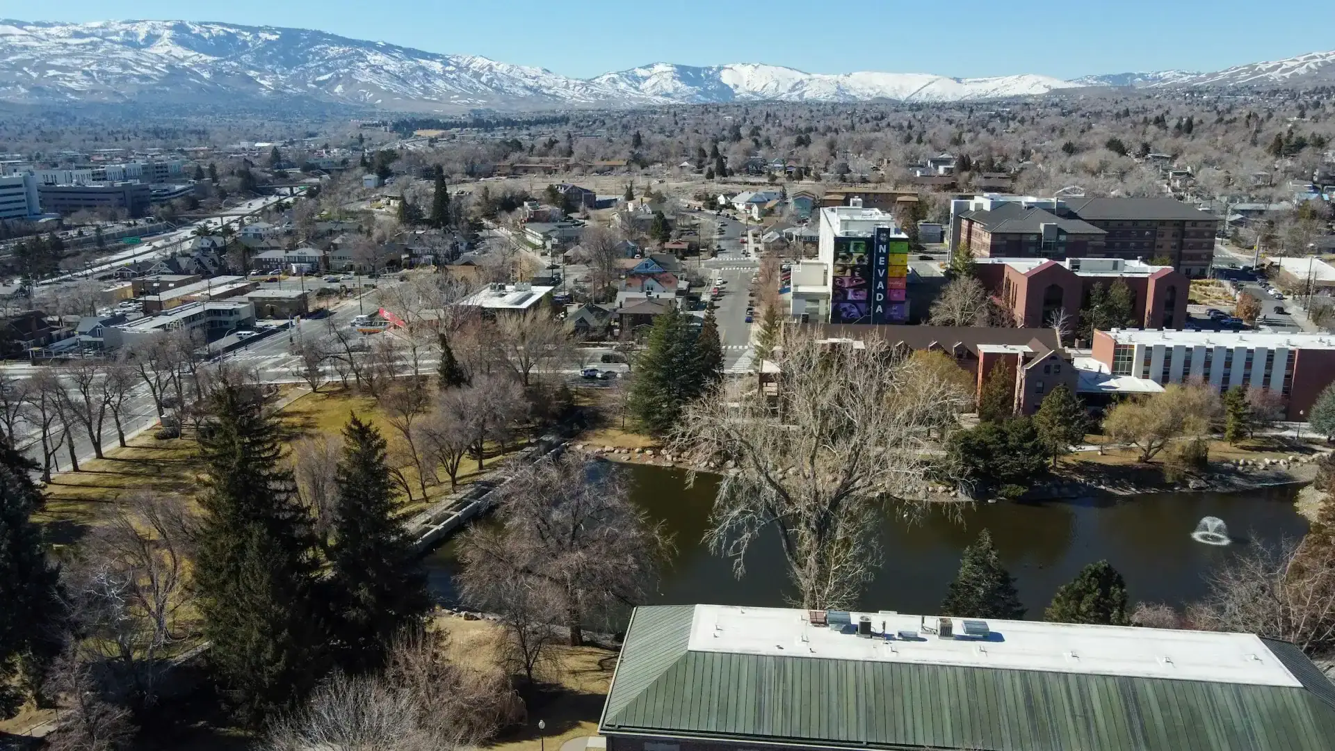 An aerial view of Reno with snowy mountains behind