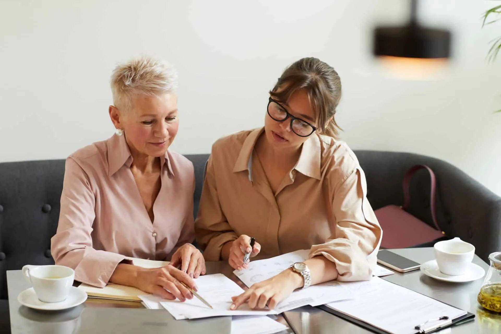 Two women reviewing documents together at a table