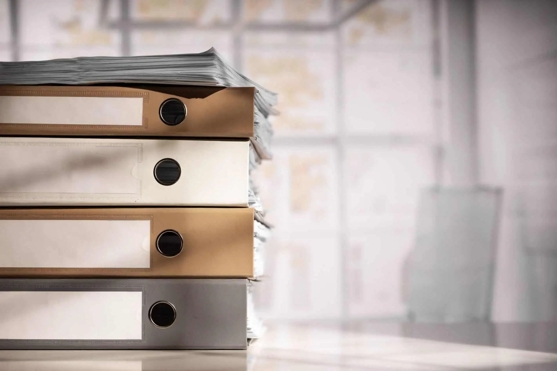 A stack of file binders on a desk